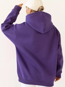 Detail view of oversized purple hoodie featuring dropped shoulders and ribbed hem back