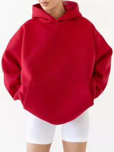 Front detail of loose red hoodie featuring drop shoulders and large kangaroo pocket