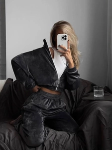 Detail of dark grey velvet two-piece tracksuit with zip-up hoodie and high-waisted pants