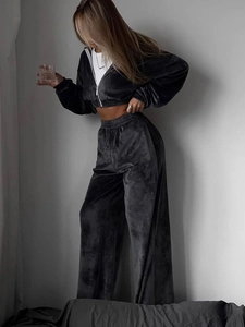 Close-up of high-quality dark velvet texture on women's cropped hoodie and wide-leg pants
