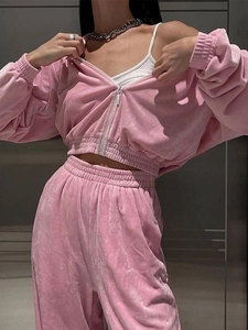 Close-up of pink velvet tracksuit showing soft texture on zip hoodie and joggers