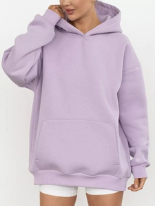 Detail of lavender oversized hoodie showing kangaroo pocket and ribbed cuffs in soft cotton