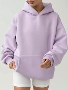 Detail view of oversized lavender hoodie featuring a kangaroo pocket and ribbed cuffs