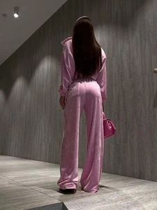 Rear view of pink velvet tracksuit showing soft texture and high-waist wide-leg pants