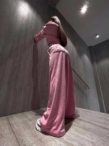 Low angle view of pink velvet tracksuit with crop top sweatshirt and wide-leg pants