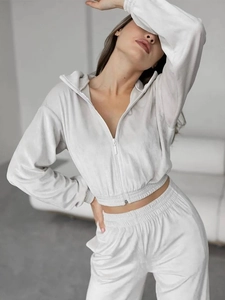 Detail of premium velvet tracksuit texture on zipped hoodie and elastic waistband pants