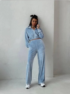 Close-up of light blue velvet tracksuit featuring zip-up jacket and wide-leg pants