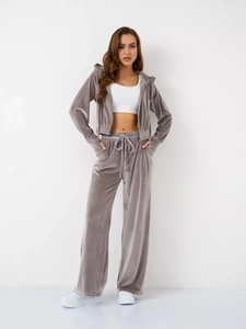 Detail of grey velvet tracksuit showing soft texture of zip-up hoodie and drawstring pants