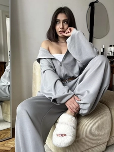 Close-up of gray two-piece tracksuit with zip-up hoodie and high-waisted wide-leg pants