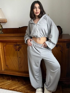 Detail of light grey cropped zip-up hoodie and high-waist loose drawstring sweatpants