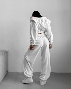 Back view of a white two-piece lounge set with a cropped hoodie and high-waist joggers