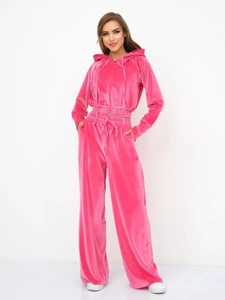 Detail of fuchsia velvet tracksuit set featuring cropped zipper hoodie and wide-leg trousers