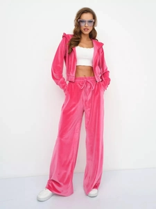 Detail of pink velvet hooded tracksuit with zipper jacket and drawstring trousers