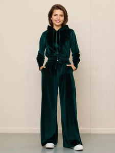 Detail of dark green velvet tracksuit with zip-up hoodie and high-waisted wide-leg pants