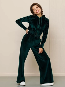 Detail of dark green velvet tracksuit featuring zip-up hoodie and high-waist wide-leg pants