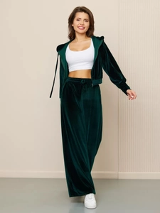 Close-up of forest green velvet tracksuit showing plush texture and drawstring detail