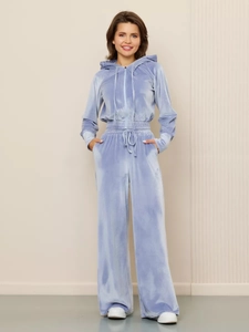 Detail of light blue velvet trackset featuring zip-up hoodie and high-waist joggers