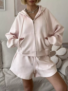 Detail of light pink hoodie with zipper and drawstring shorts in soft cotton fabric