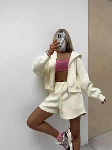 Detail of cream oversized zip hoodie and wide-leg shorts with pink tube top inner wear