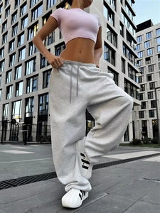 Dettaglio di pantaloni larghi grigio chiaro con coulisse in vita in stile street