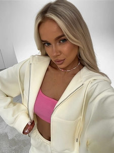 Detail of cream oversized zip-up hoodie and matching joggers with elastic waistband