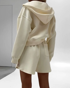 Back view of cream knit cotton hoodie and matching shorts set with elastic waist and pocket