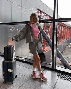 Detail of grey hooded zip-up sweatshirt with pink crop top and shorts three-piece set
