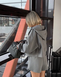 Detail of grey hooded sweatshirt and shorts set featuring premium cotton knit texture
