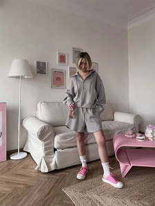 Detailed texture of grey hoodie and wide-leg shorts made of soft sweatshirt fabric