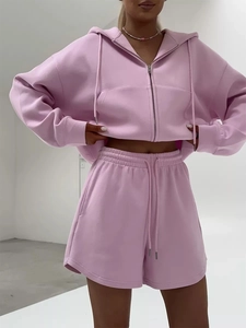 Close-up of pink zip-up hoodie and high-waist shorts set with drawstring details