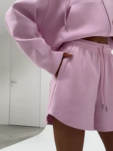 Detail view of pink cotton hoodie set showing drawstring waist and metallic aglet tips