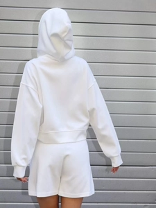 Back view of white hooded sweatshirt and matching shorts set in soft cotton fabric
