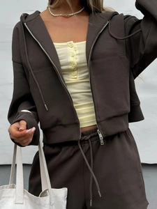 Detail of dark brown hooded sweatshirt with zip-up design and matching drawstring joggers