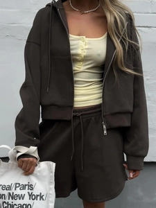 Detail view of dark brown hooded sweatshirt and matching shorts set with high quality texture