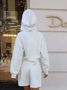 Detail of light grey knitted hoodie and shorts set showing fabric texture from behind