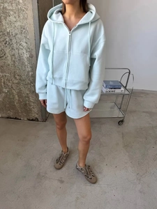 Close-up of light blue zip-up hoodie and matching shorts set with drawstrings