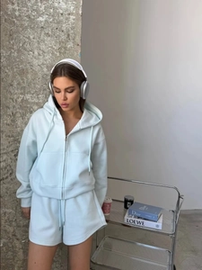Detailed view of the mint green drawstring shorts and fabric texture of the casual set