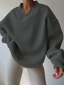 Detail of dark grey oversized sweatshirt featuring a unique V-stitch ribbed neckline