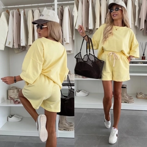 Detail of light yellow knit t-shirt and drawstring shorts set with a relaxed fit