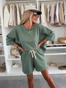 Detail of drawstring waist and knit fabric on women's casual dark green two-piece set