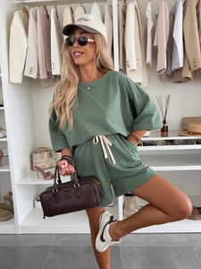 Detail of sage green lounge set showing elastic waistband with contrast white drawstring
