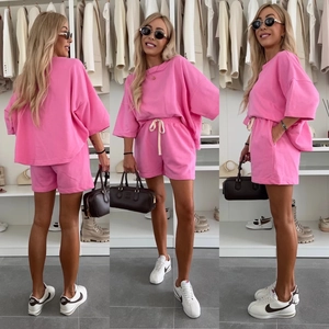 Three-way view of a pink short sleeve T-shirt and drawstring shorts two-piece casual set