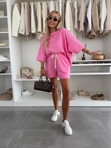 Detail of bright pink casual short sleeve T-shirt and drawstring shorts two-piece set