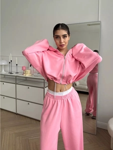Detail of pink cropped zip-up hoodie drawstring hem and high waist wide leg pants set