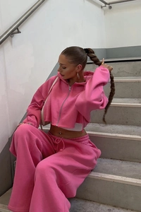 Detail view of pink cropped zip-up hoodie and high-waist wide-leg sweatpants set