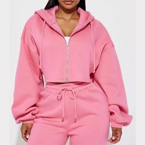 Detailed view of pink two-piece tracksuit with zip-up hoodie and high-waist joggers