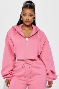 Detail of pink cropped zip-up hoodie and high-waisted joggers with drawstring