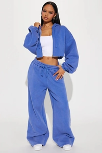Close-up of blue cropped zip-up hoodie and wide-leg sweatpants in thick fleece fabric