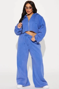 Close-up of royal blue cropped hoodie with raw hem and drawstring wide leg sweatpants