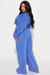 Detail of royal blue hooded sweatshirt and high-waisted wide-leg joggers set